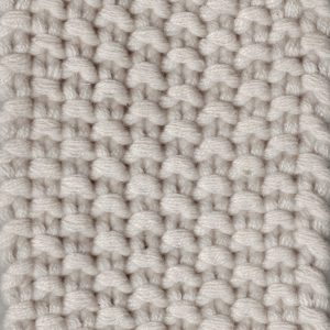 Soft ivory cashmere sample in a seed stitch pattern, highlighting a subtle, textured surface with a plush hand feel.